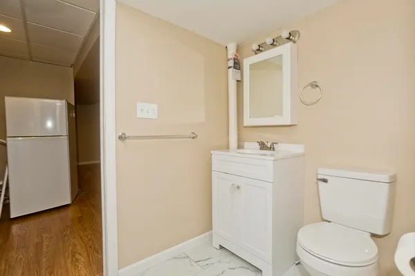 a bathroom with a toilet a sink and a mirror