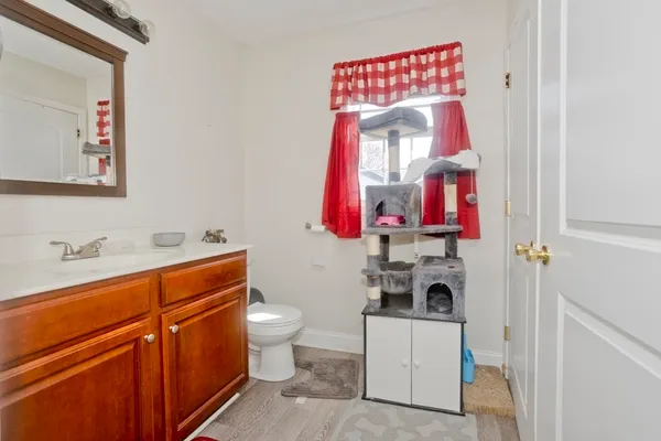 a bathroom with a toilet sink and mirror