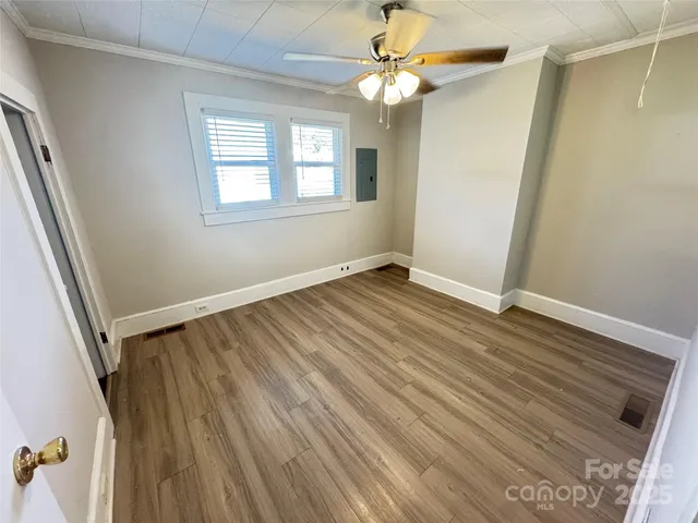 wooden floor in an empty room with a window