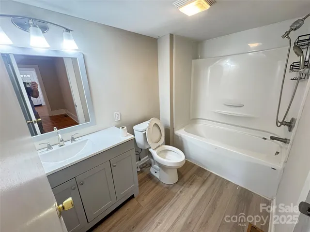 a bathroom with a sink toilet a tub and shower