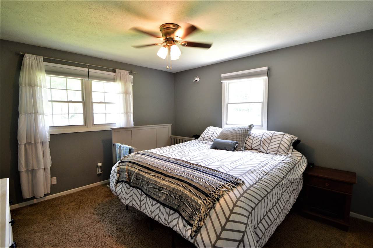 4830 Crown Point Circle Roscoe, IL 61073 - Photo 12 of 19 a bedroom with a bed and a chandelier