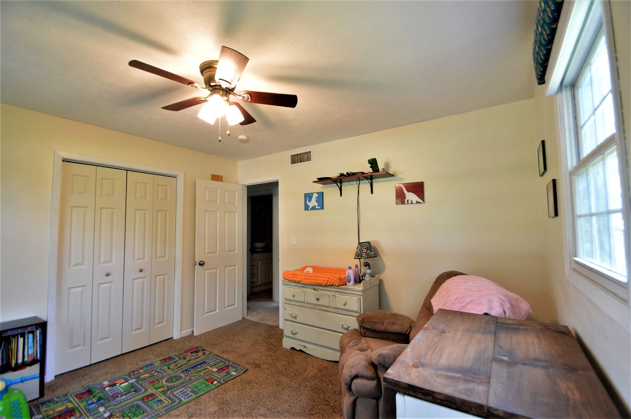 4830 Crown Point Circle Roscoe, IL 61073 - Photo 13 of 19 a bedroom with a bed and a chandelier