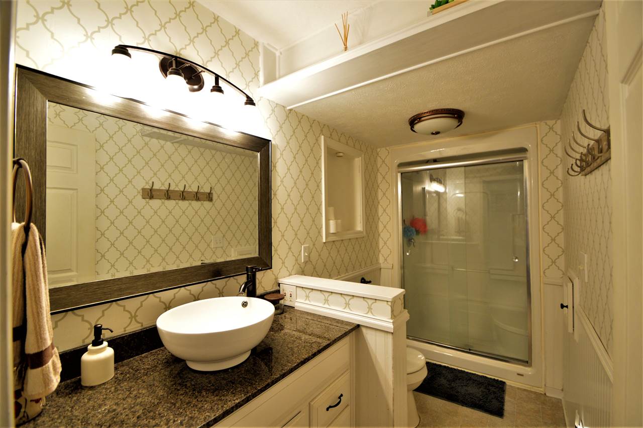 4830 Crown Point Circle Roscoe, IL 61073 - Photo 14 of 19 a bathroom with a granite countertop sink toilet and shower