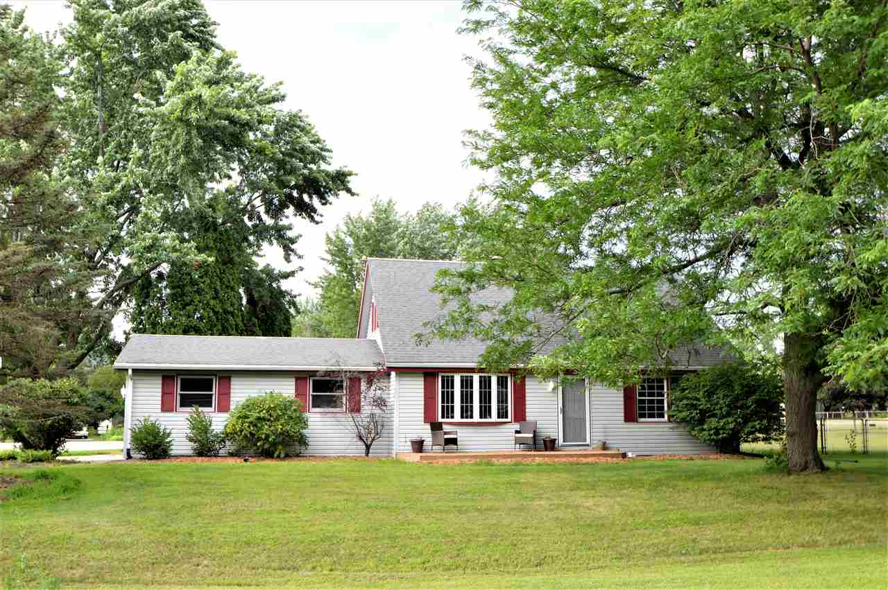 4830 Crown Point Circle Roscoe, IL 61073 - Photo 2 of 19 a view of a house with a big yard and potted plants and large trees