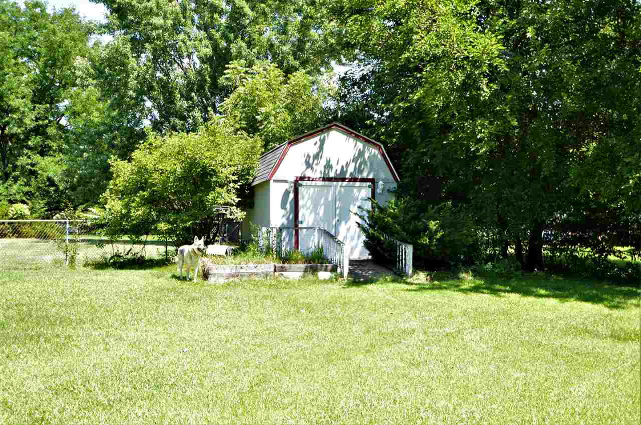 4830 Crown Point Circle Roscoe, IL 61073 - Photo 4 of 19 a view of swimming pool with a bench and trees in the background