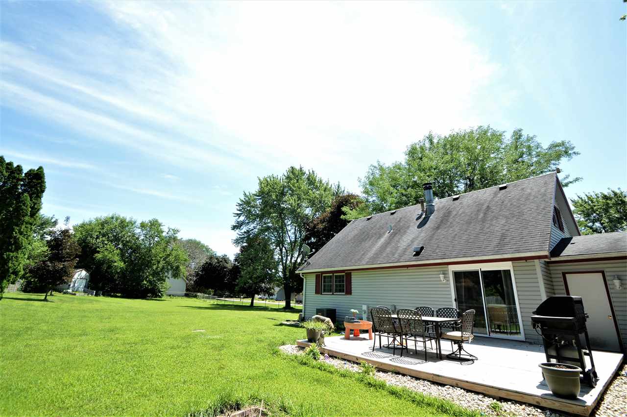 4830 Crown Point Circle Roscoe, IL 61073 - Photo 5 of 19 a backyard of a house with table and chairs