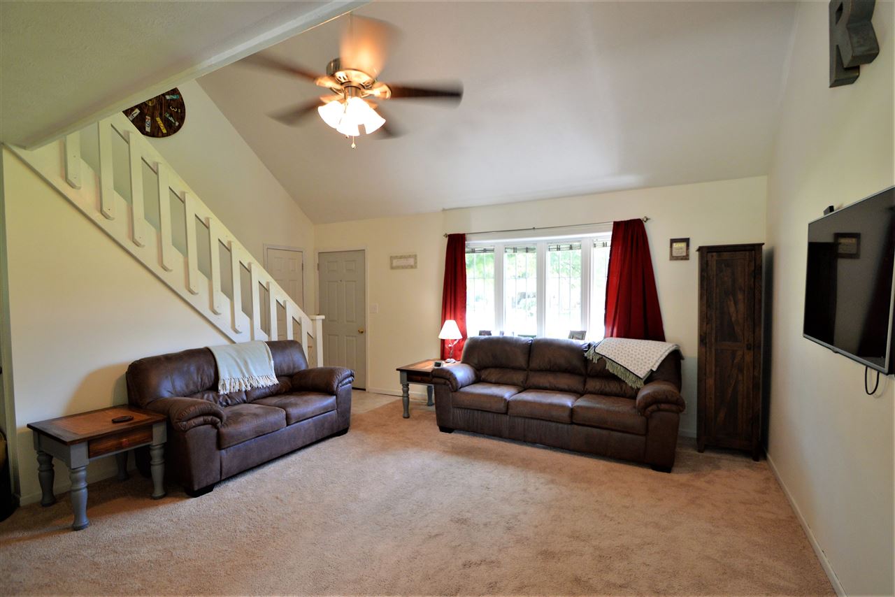 4830 Crown Point Circle Roscoe, IL 61073 - Photo 8 of 19 a living room with furniture and a flat screen tv