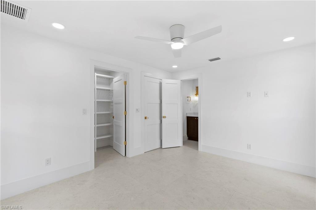 17 Knights Bridge Road Naples, FL 34112 - Photo 11 of 18 an empty room with closet and windows