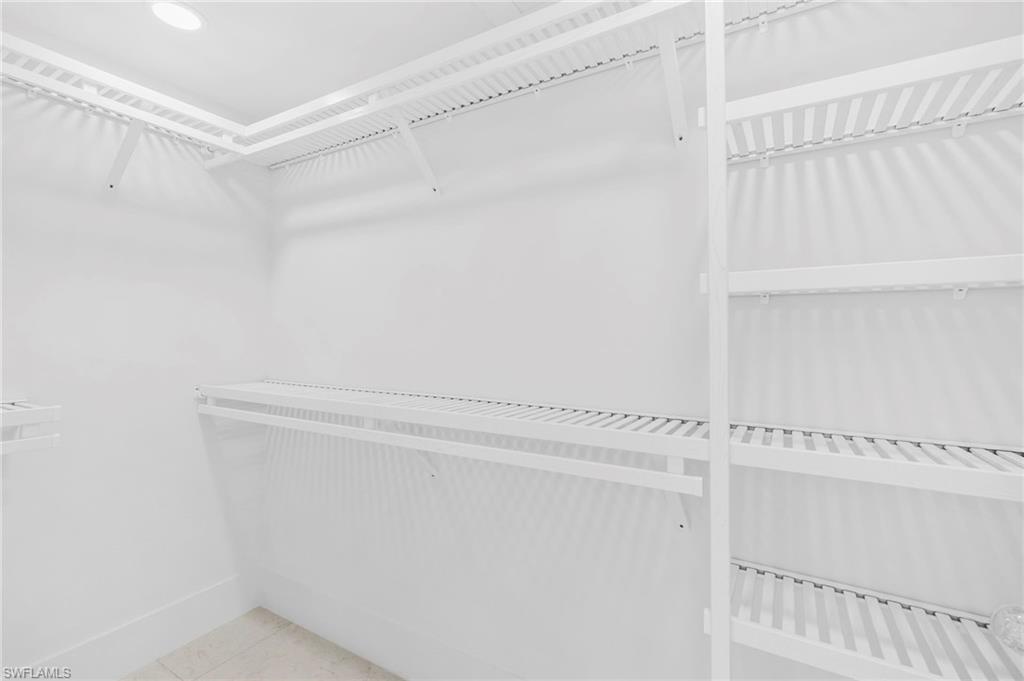 17 Knights Bridge Road Naples, FL 34112 - Photo 12 of 18 a view of walk in closet with empty racks