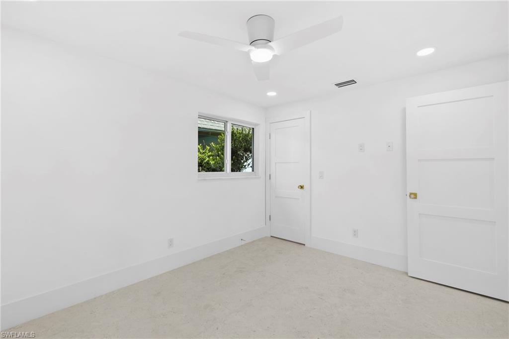 17 Knights Bridge Road Naples, FL 34112 - Photo 14 of 18 an empty room with windows and closet