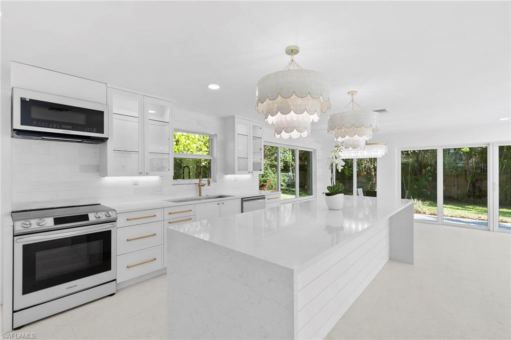 17 Knights Bridge Road Naples, FL 34112 - Photo 16 of 18 a large white kitchen with a large window