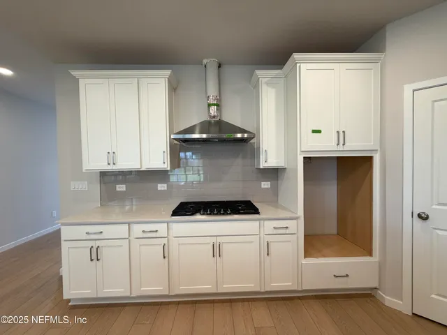 a kitchen with kitchen island a sink and a large window