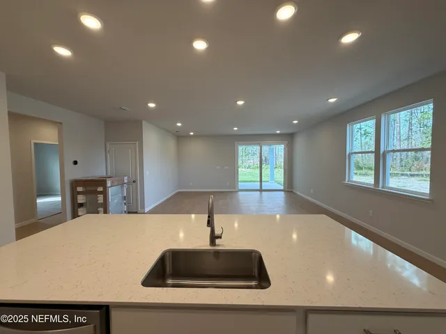 a view of kitchen with kitchen island wooden floor and center island