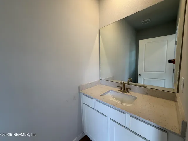 a room with kitchen island sink and center island