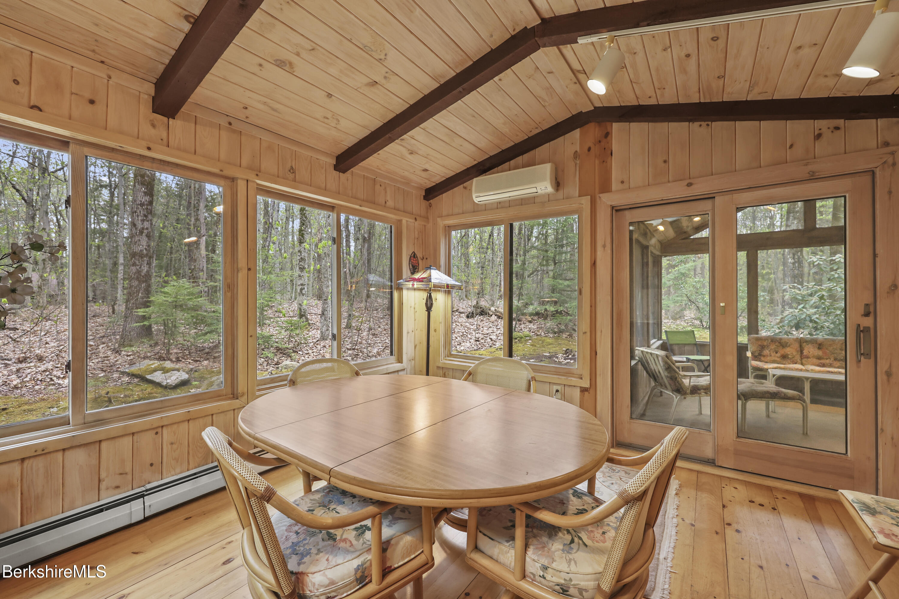 422 Bonny Rigg Hill Road Becket, MA 01223 - Photo 35 of 60 a dining room with furniture large windows and wooden floor