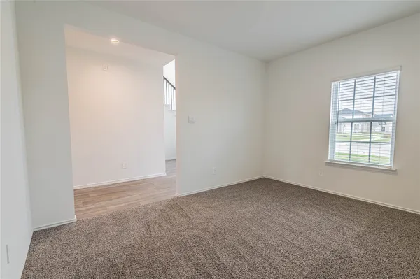 an empty room with a empty space and windows