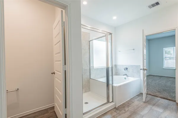 a bathroom with a tub and shower