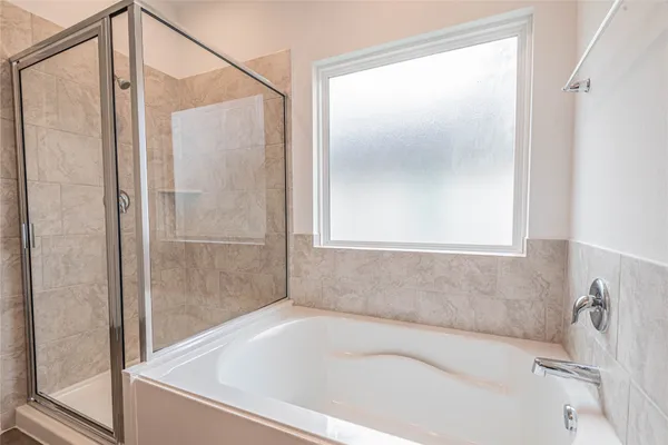 a bathroom with a bathtub and a shower