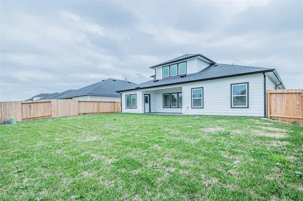 a view of a house with yard and a garden