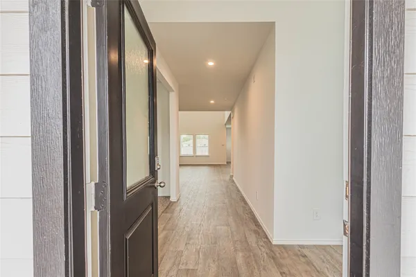 a view of hallway with wooden floor