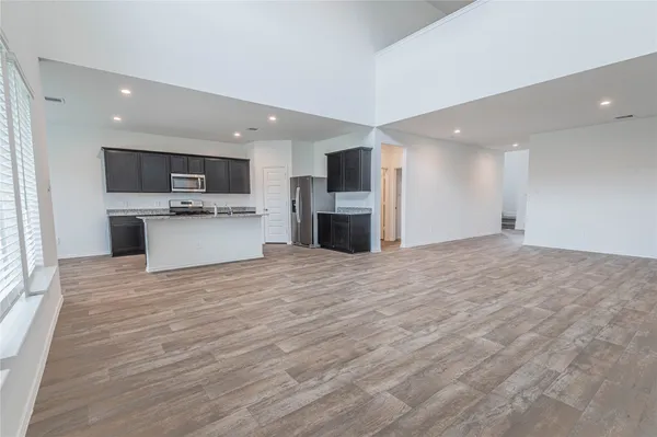 a view of a kitchen with a sink and a refrigerator