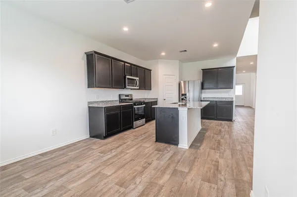 a kitchen with stainless steel appliances a refrigerator sink and microwave