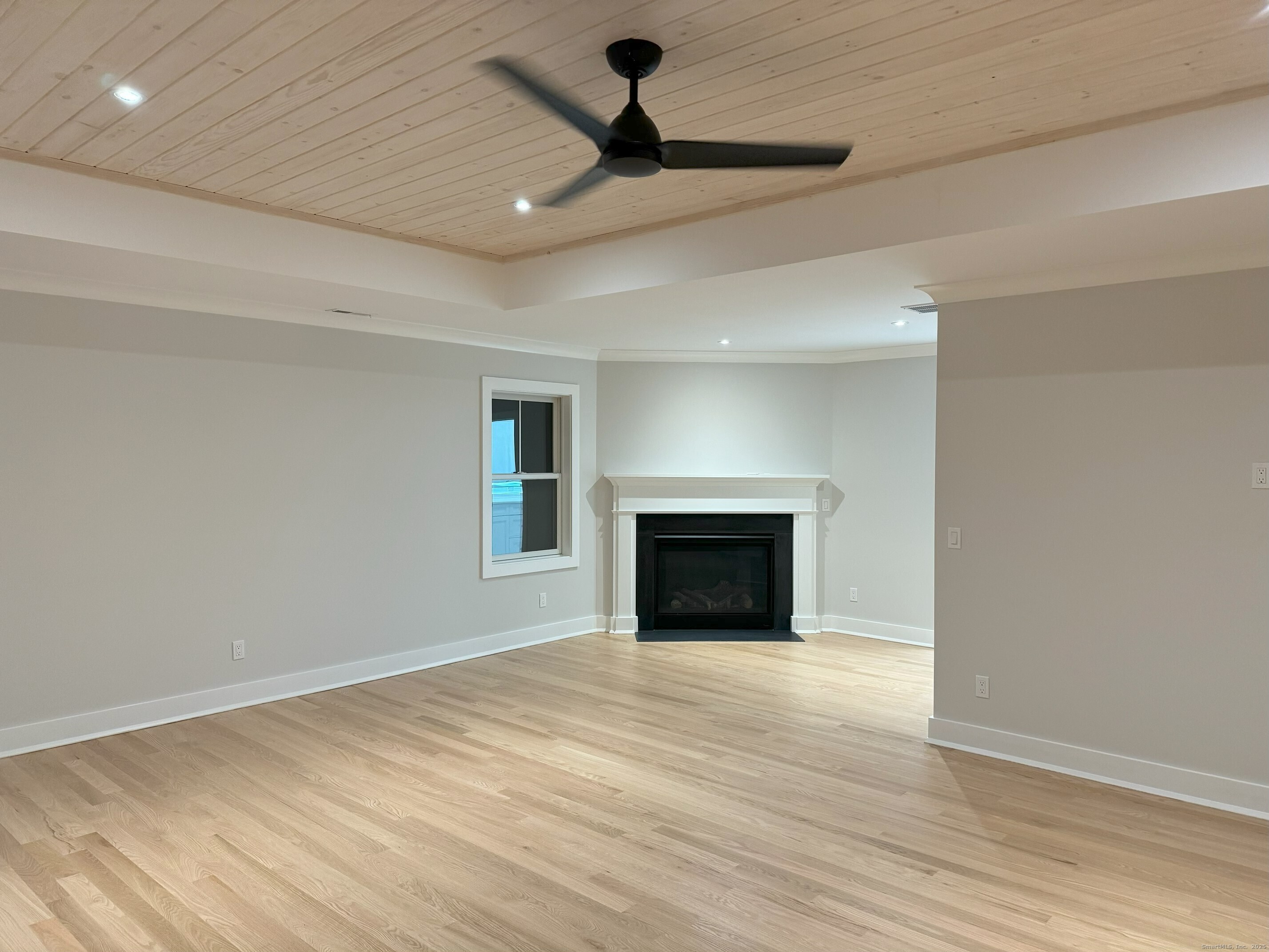 109 Signal Hill Road Wilton, CT 06897 - Photo 12 of 18 a view of empty room with wooden floor and fan