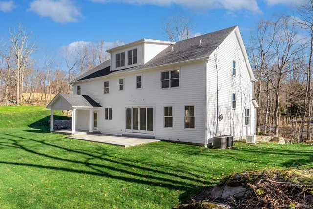 a front view of a house with a yard table and chairs