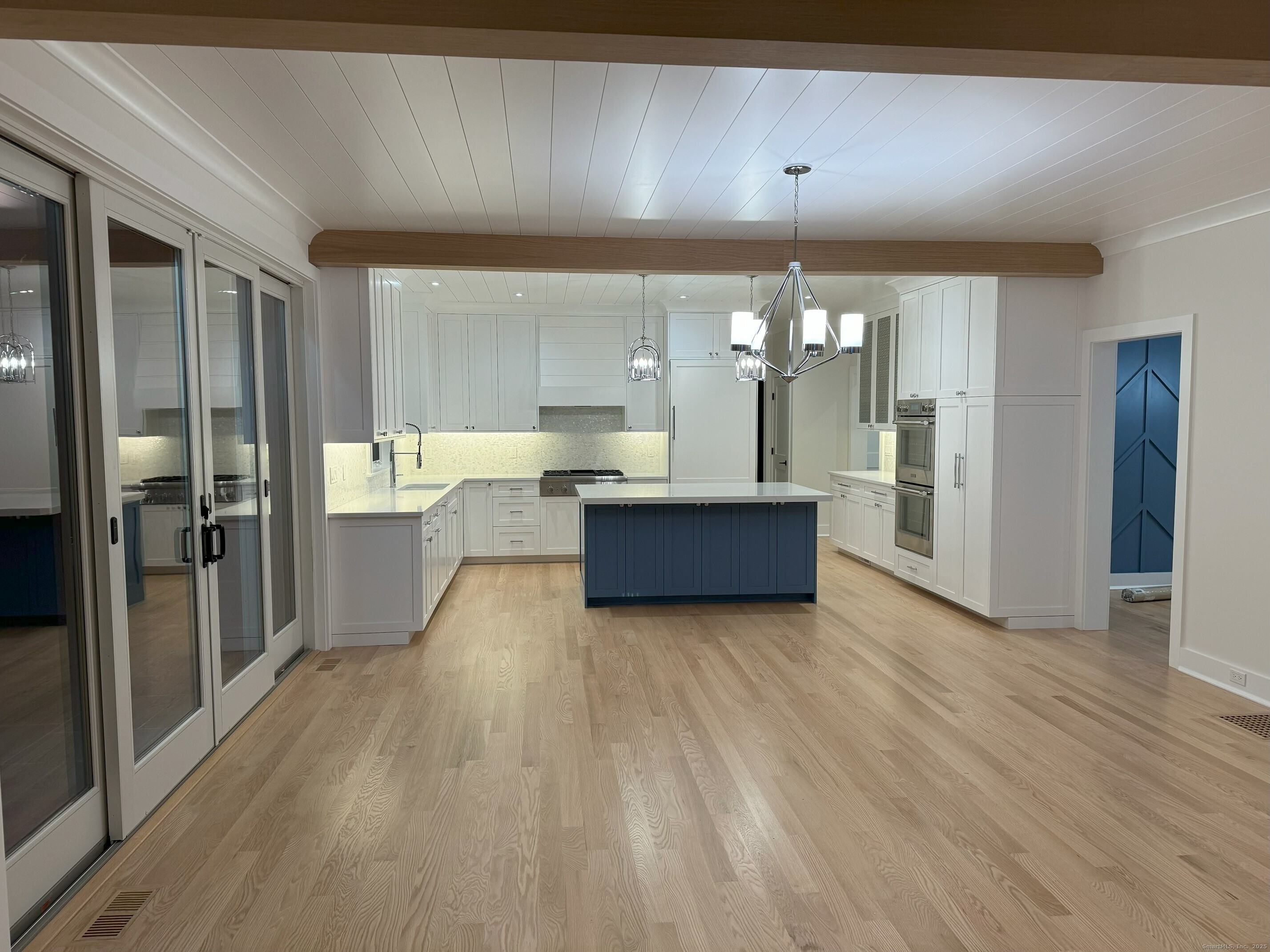 109 Signal Hill Road Wilton, CT 06897 - Photo 2 of 18 a view of a kitchen with a sink cabinet and a living room