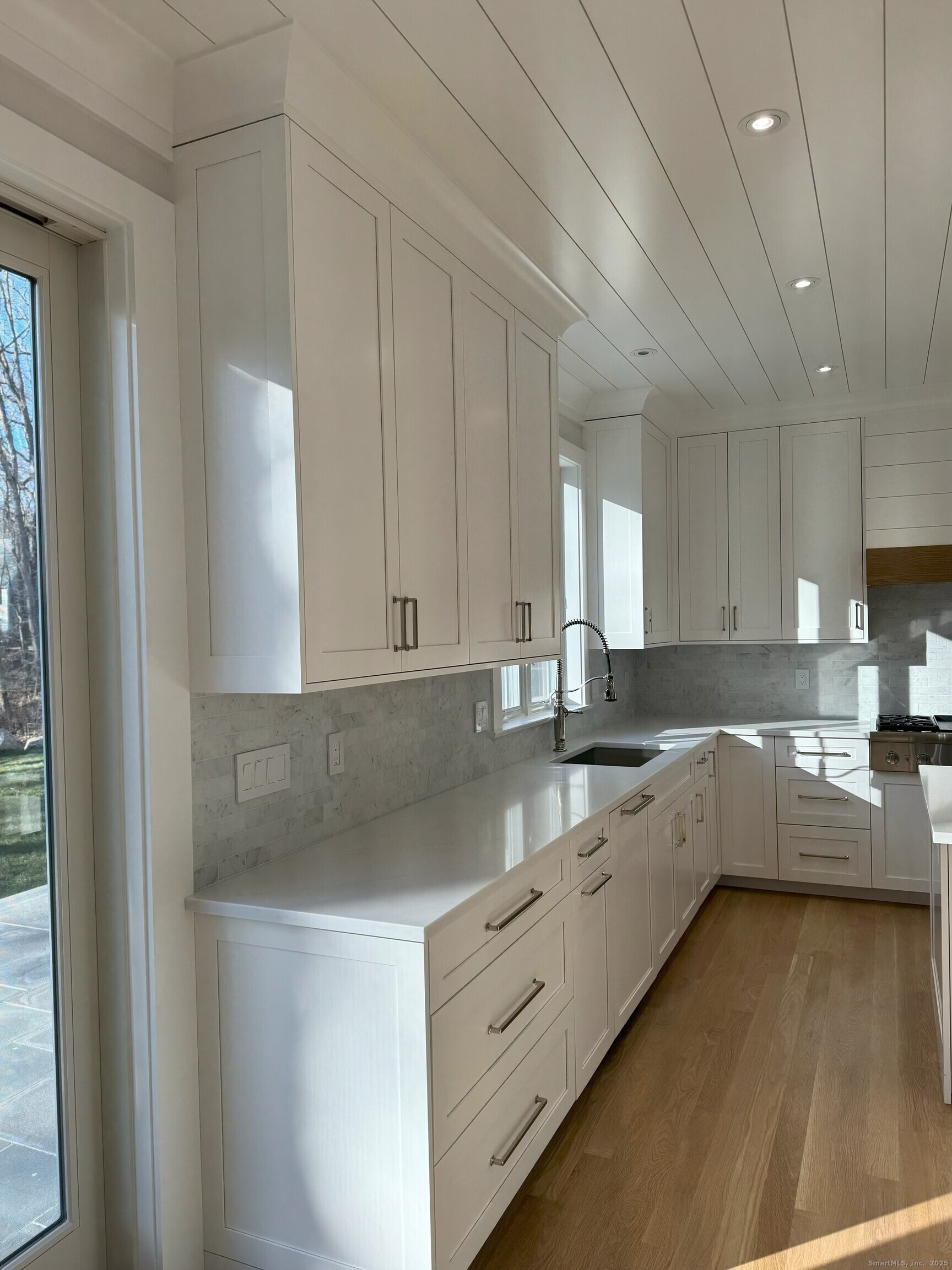109 Signal Hill Road Wilton, CT 06897 - Photo 3 of 18 a kitchen with granite countertop white cabinets and white appliances