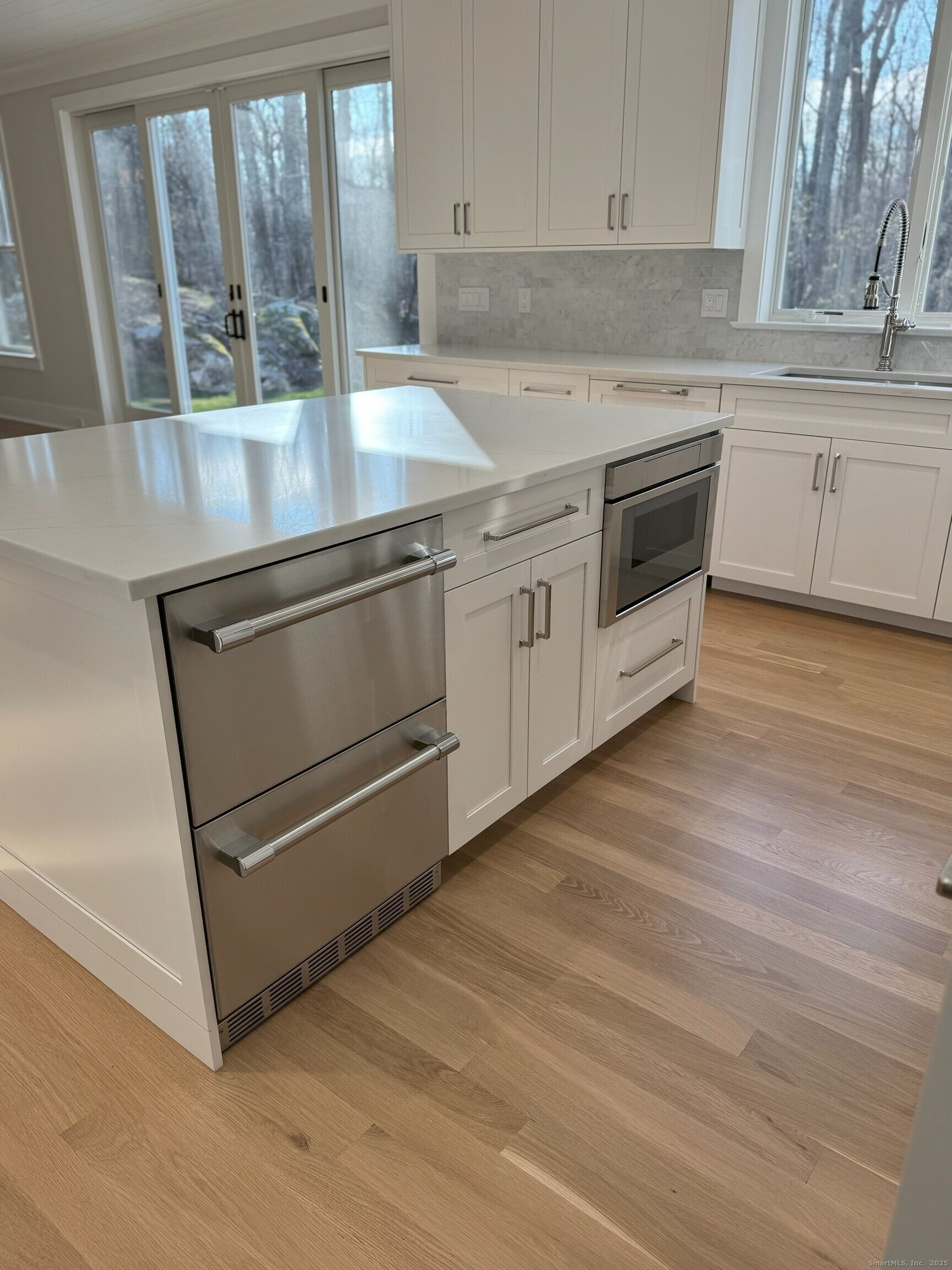 109 Signal Hill Road Wilton, CT 06897 - Photo 4 of 18 a kitchen with granite countertop white cabinets and white appliances