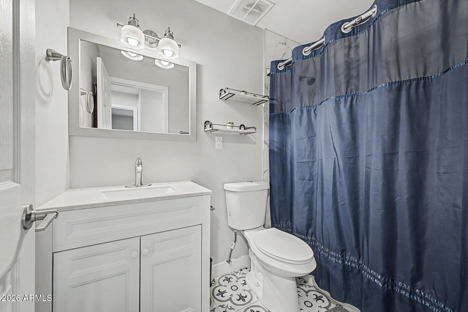 955 East Marigold Lane Tempe, AZ 85288 - Photo 21 of 32 a bathroom with a sink a toilet a mirror and shower
