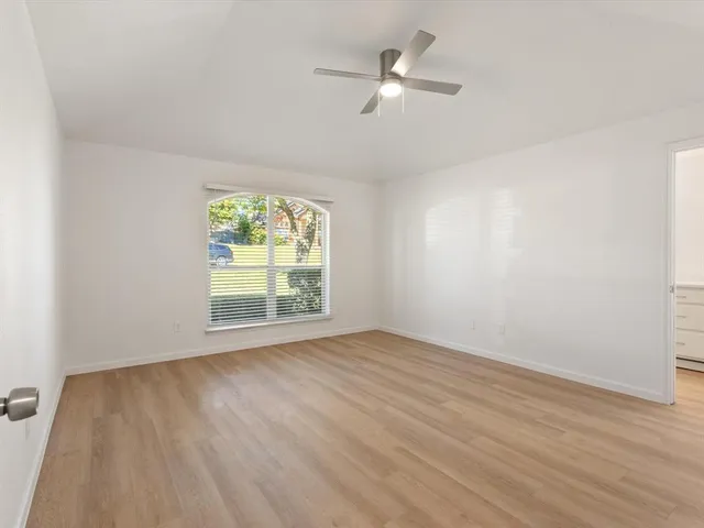 a kitchen with granite countertop white cabinets and stainless steel appliances