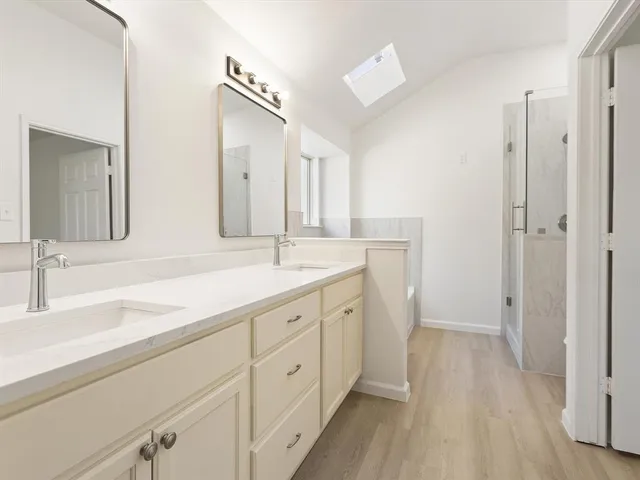 a spacious bathroom with a double vanity sink mirror and