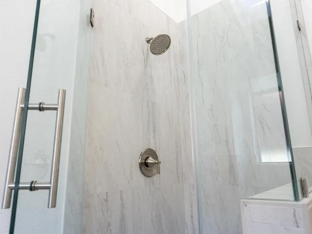 a bathroom with a bathtub and shower