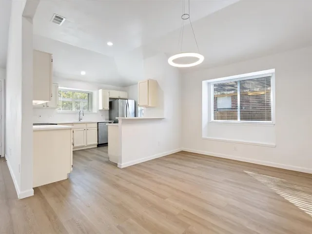 a view of a kitchen with an empty space and a window