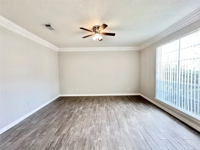 wooden floor in an empty room with a window