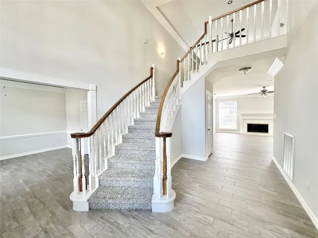 a view of entryway and hall with wooden floor