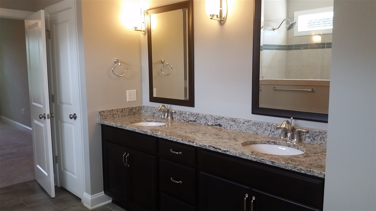 11812 Friendship Oak Trail Raleigh, NC 27613 - Photo 15 of 24 Dual granite topped vanity with custom lighting.