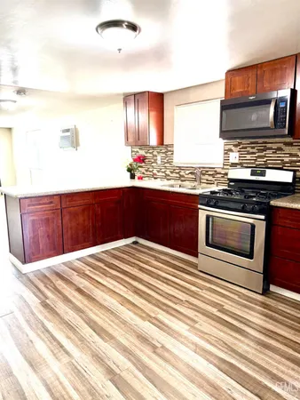 a kitchen with stainless steel appliances granite countertop a stove and a sink