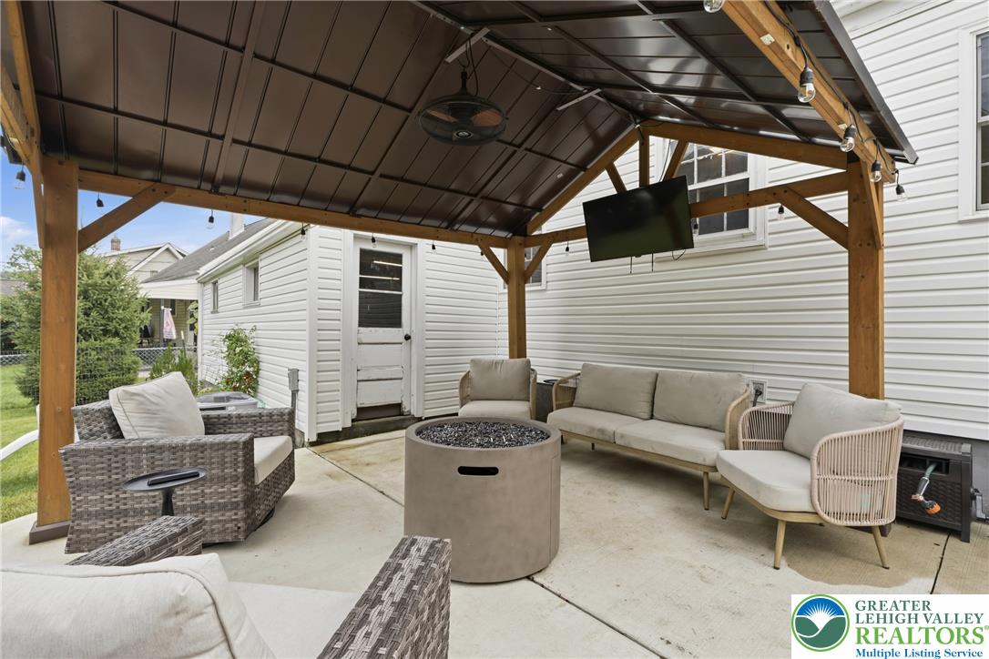 408 Maple Road Hellertown, PA 18055 - Photo 49 of 66 A sheltered concrete patio features a vaulted wood-framed pavilion over a spacious entertaining area.