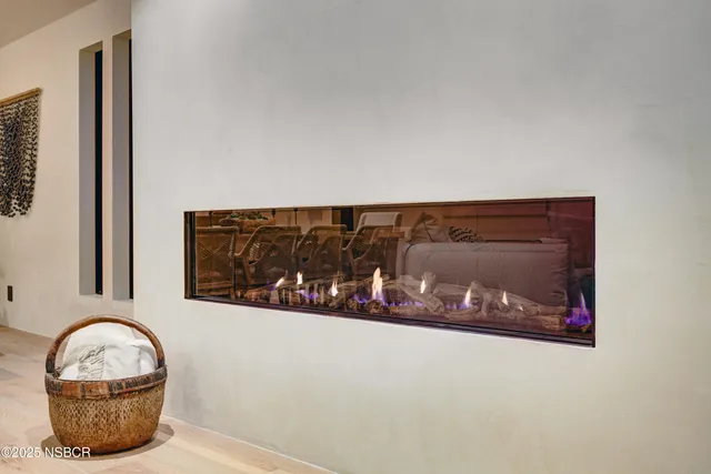 a living room with fireplace furniture and a wooden floor