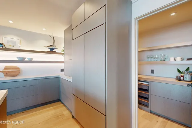 a bathroom with a sink a large mirror and a shower