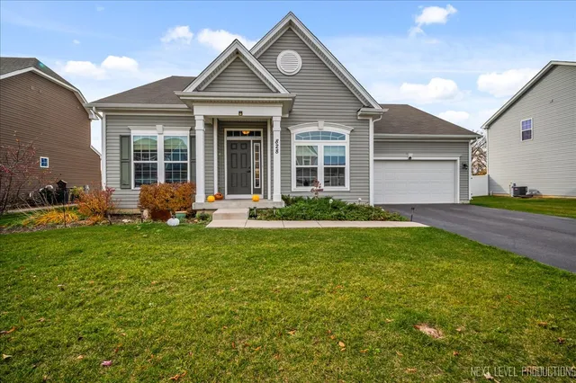 a front view of a house with a yard and garage