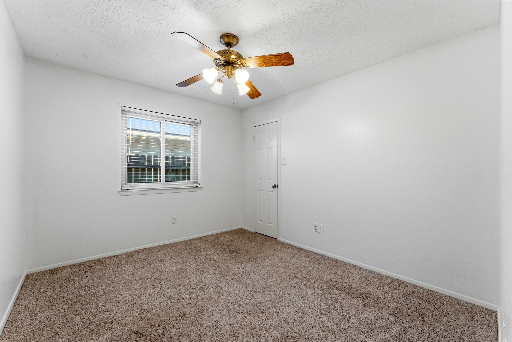 21514 Slippery Creek Lane Spring, TX 77388 - Photo 19 of 27 an empty room with windows and chandelier fan