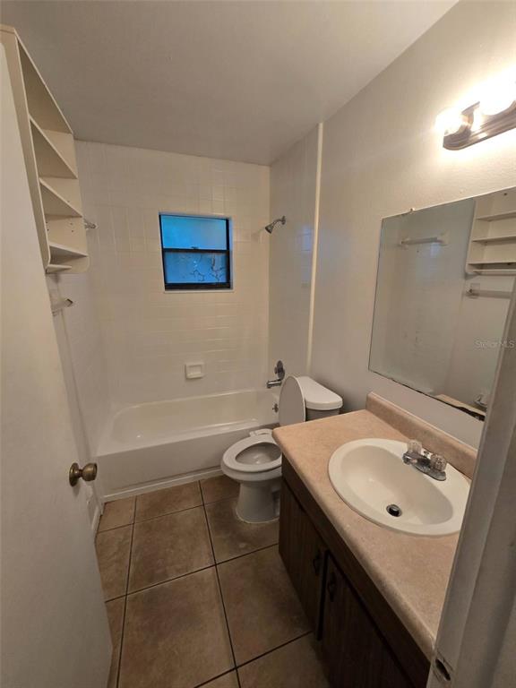 1507 Tennessee Avenue St. Cloud, FL 34769 - Photo 9 of 10 a bathroom with a sink a toilet and shower