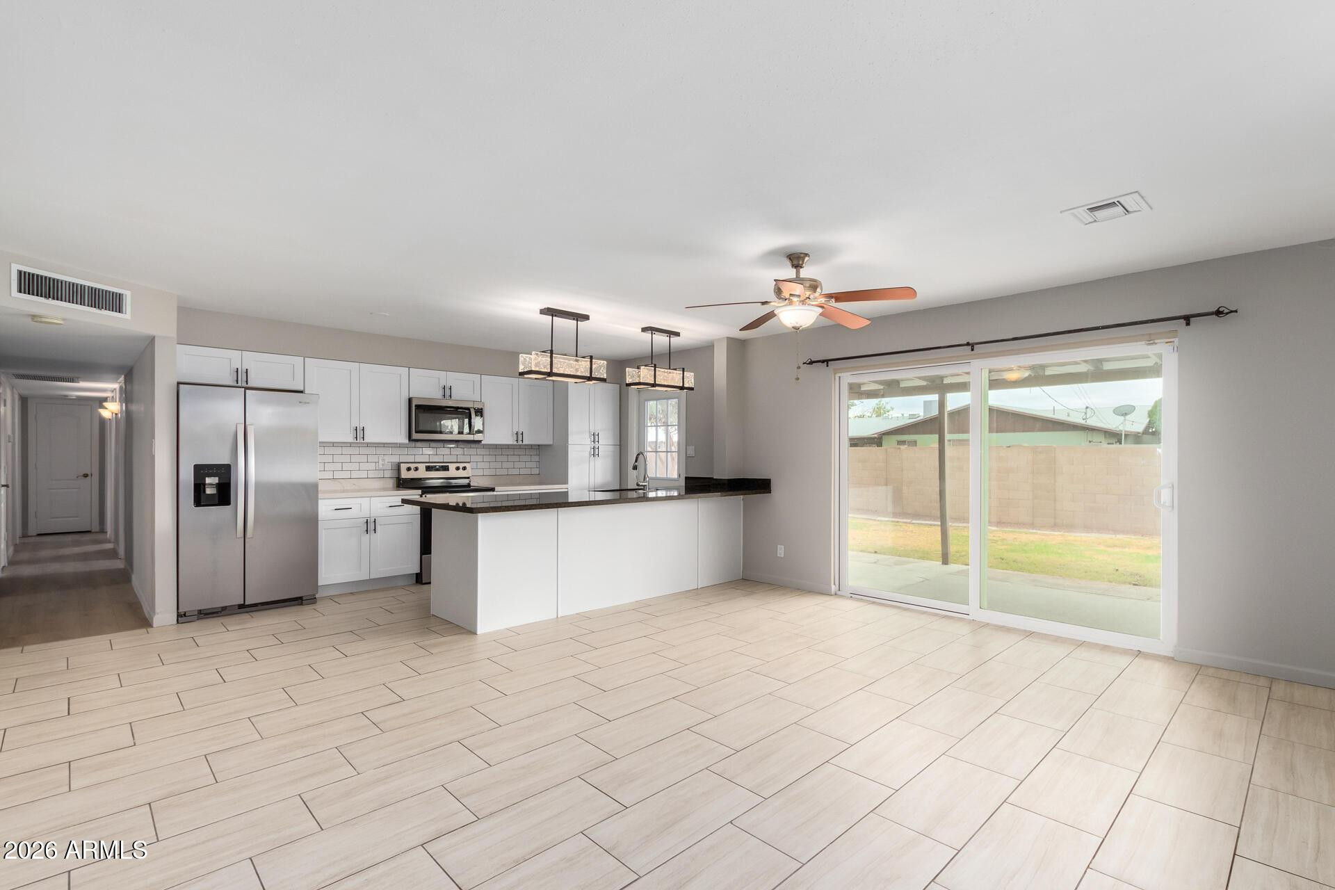 103 East Del Rio Drive Tempe, AZ 85282 - Photo 11 of 28 a large kitchen with kitchen island a stove a sink dishwasher and a refrigerator