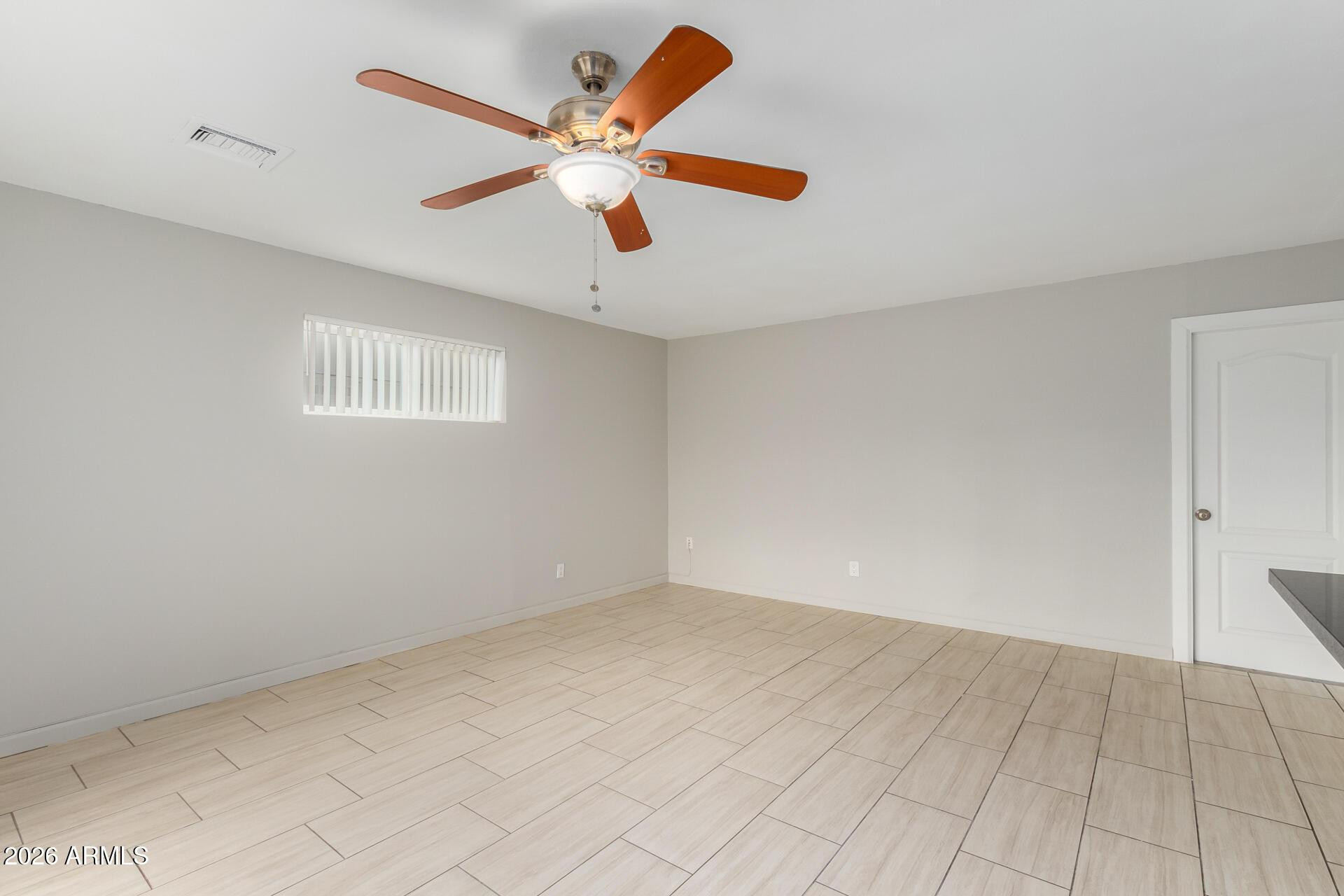 103 East Del Rio Drive Tempe, AZ 85282 - Photo 13 of 28 an empty room with wooden floor and windows