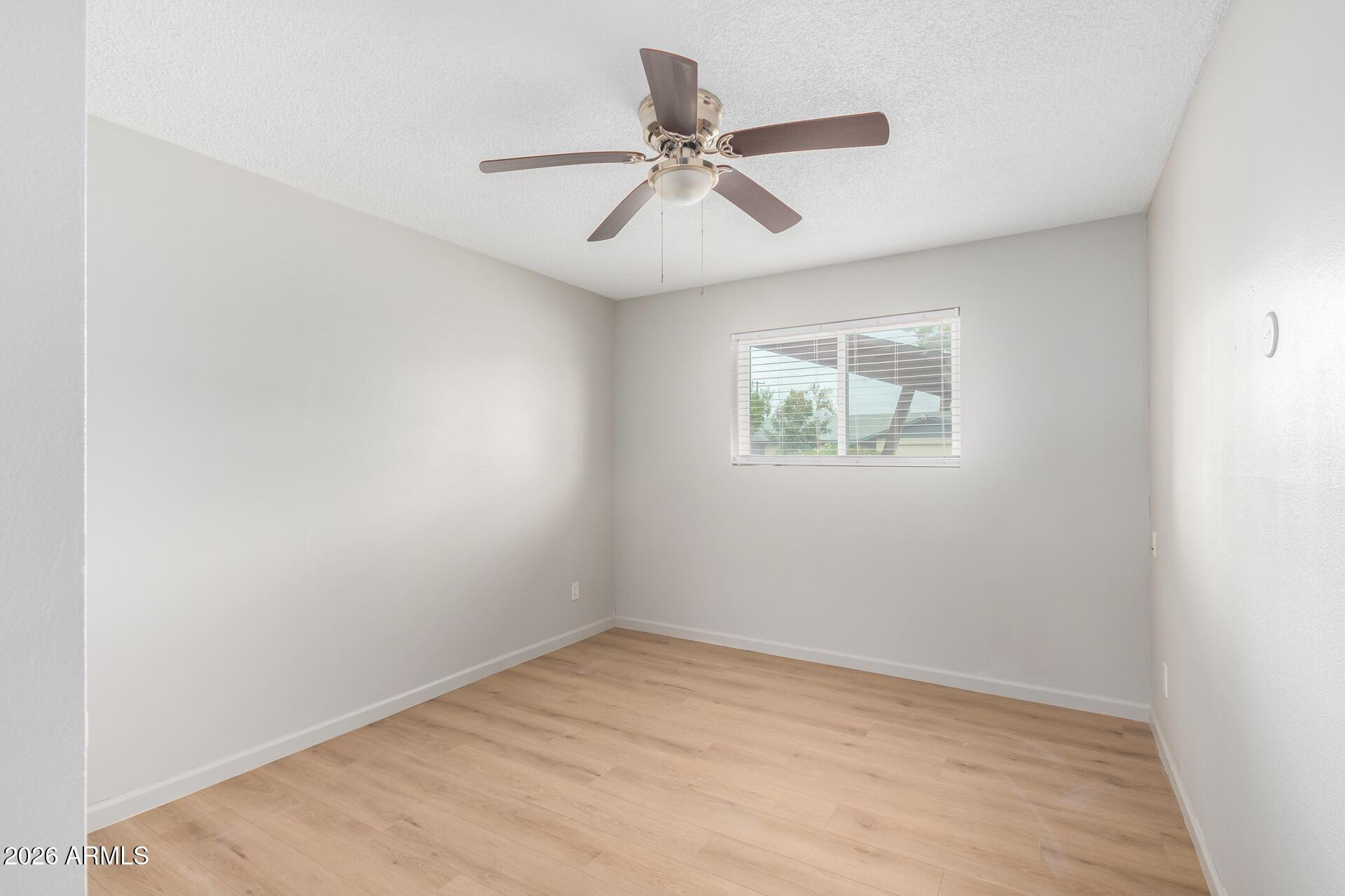 103 East Del Rio Drive Tempe, AZ 85282 - Photo 17 of 28 an empty room with a window and a fan