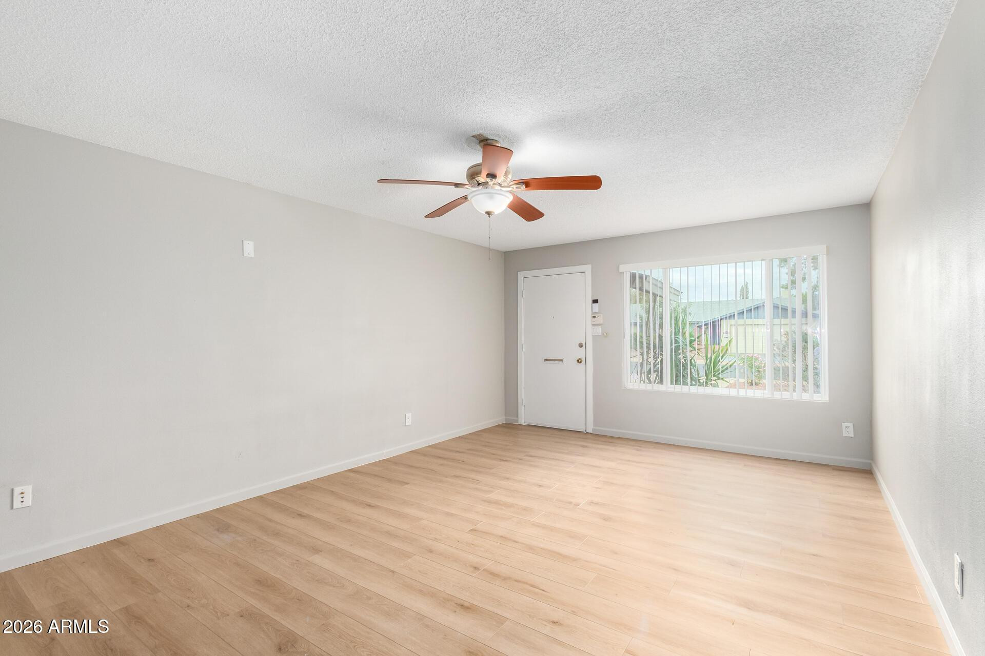 103 East Del Rio Drive Tempe, AZ 85282 - Photo 4 of 28 wooden floor in an empty room with a window